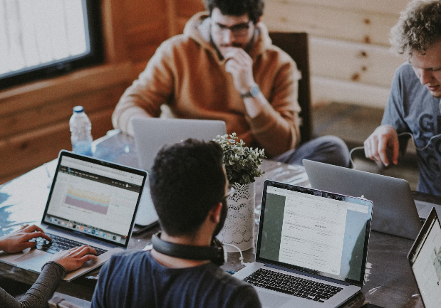 Team collaboration - people working together on laptops